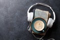 Audio book concept. Headphones, coffee and book Royalty Free Stock Photo