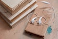 Audio book concept. Headphones, coffee and book over wooden table. Top view with space for your text