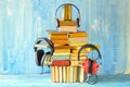 audio book concept with heap of books and set of vintage headphones, grungy background, free copy space Royalty Free Stock Photo