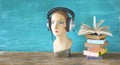 Audio book concept with open book headphones and display dummy, mannequin, panoramic, copy space Royalty Free Stock Photo