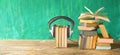 Audio book concept with opened book, row of books and headphones, panorama format on grungy background, copy space Royalty Free Stock Photo