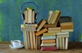 Audio book concept, with stack of books, headphones and cup of coffee Royalty Free Stock Photo