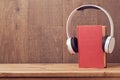 Audio books concept with old book and headphones Royalty Free Stock Photo