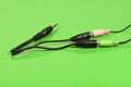 Audio cable splitter, stereo male to two female stereo audio jack 3,5 mm, isolated on a green background. Extreme closeup Royalty Free Stock Photo