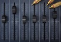 Audio mixer with foreground faders and audio cables with golden rca connectors Royalty Free Stock Photo