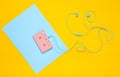 Audio cassette and earphones on a blue yellow pastel background. Musical concept. Retro style. Minimalism. Top View.