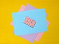 Audio cassette on a pastel-colored paper background. Retro media technology 80s. Music, entertainment. Top view. minimalism trend.