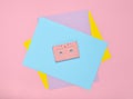 Audio cassette on a pastel-colored paper background. Retro media technology 80s. Music, entertainment. Top view. minimalism trend. Royalty Free Stock Photo