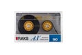 Audio cassette RAKS isolated. Back view compact audio cassette RAKS AX 90 in transparent case box. IEC type I normal