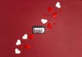 Audio cassette tape with hearts on red background. Place for song title. Romantic mood music concept Royalty Free Stock Photo