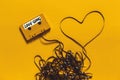 Audio Cassette Tape With The Inscription Love Song And Heart On A Yellow Background. Retro Technology Romance Concept