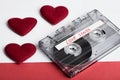 Audio cassette tape on red backgound with fabric heart Royalty Free Stock Photo