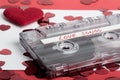 Audio cassette tape on red backgound with fabric heart Royalty Free Stock Photo