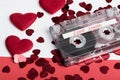 Audio cassette tape on red backgound with fabric heart Royalty Free Stock Photo