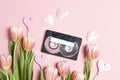 Audio cassette tape with tulips and hearts on pink background. Romantic spring mood music concept Royalty Free Stock Photo