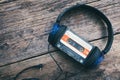 Audio compact cassette tape and headphones background Royalty Free Stock Photo