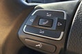 Audio control buttons on the steering wheel in a modern car closeup Royalty Free Stock Photo