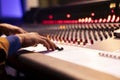 Audio expert recording and editing music with mixing console panel board