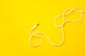Audio jack with white cable on yellow background Royalty Free Stock Photo