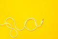 Audio jack with white cable on yellow background Royalty Free Stock Photo