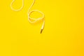 Audio jack with white cable on yellow background Royalty Free Stock Photo