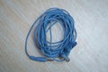 Audio Mini Jack Cable for microphone isolated on wooden background . Blue Microphone and headphone splitter cable