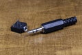Audio mini plug on wooden background. Connectors m- and f- types. Royalty Free Stock Photo