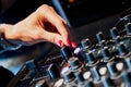 Audio mixer console and professional sound mixing. A hand is adjusting audio mixer with buttons and sliders. Mixer console for mus Royalty Free Stock Photo