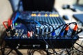 Audio mixer in a recording studio with wires and plugs. Blurred focus Royalty Free Stock Photo