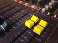 Audio mixing console channel yellow knobs and buttons closeup Royalty Free Stock Photo