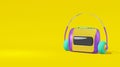 Audio player cassette cartoon style yellow background. Realistic concept toy tape recorder, headphones purple, green text space Royalty Free Stock Photo