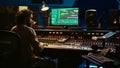 Audio technician uses mixing and mastering techniques in studio