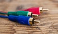 audio video analog cable on old wood background, red ,green ,blue color concept Royalty Free Stock Photo