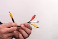 Audio video cable RCA jack in a man's hands on a white background. Royalty Free Stock Photo