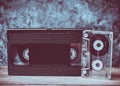 Audio and video cassette close-up on a wooden shelf against Royalty Free Stock Photo