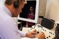 Audiologist Carrying Out Hearing Test On Female Patient