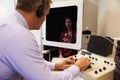 Audiologist Carrying Out Hearing Test On Female Patient