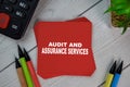 Audit and Assurance Services write on sticky notes isolated on Wooden Table