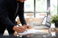 Audit man writing something on notebook paper finance control co