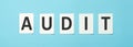 Audit text on white paper on a blue background, Business Concept. Royalty Free Stock Photo