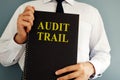 Audit trail concept. Auditor holding book. Royalty Free Stock Photo