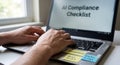 Auditing artificial intelligence with an AI compliance checklist on a laptop Royalty Free Stock Photo