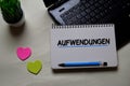 Aufwendungen write on a book isolated on office desk. German Language it means Operating Costs