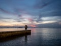 30 aug 20, Chonburi, Thailand. people looking at beautiful sunset on jetty. two people enjoy the evening view.