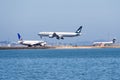 Aug 31, 2019 San Francisco / CA / USA - Busy runway at the San Francisco International Airport, with two air crafts waiting to