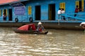 Aug : 29 : 2018 - SIEM REAP, CAMBODIA - Mother taking children to School by boat in floating village on Tonle Sap Lake.