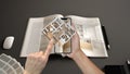 Augmented reality concept. Hand holding smartphone with AR application used to simulate 3d pop-up interactive house maps to life Royalty Free Stock Photo