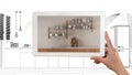 Augmented reality concept. Hand holding tablet with AR application used to simulate furniture products in custom architecture