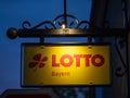 Augsburg, Germany - May 5, 2019: Image of illuminated yellow sign with red Lotto letters in Bavaria