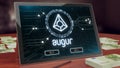 Augur cryptocurrency logo on the pc tablet display. Neon bright blockchain symbol.